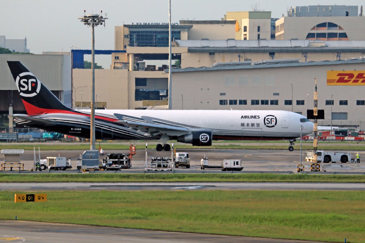 Crafting Captivating Headlines: Your awesome post title goes here SF Airlines cargo aircraft parked on the airport tarmac near a DHL building.