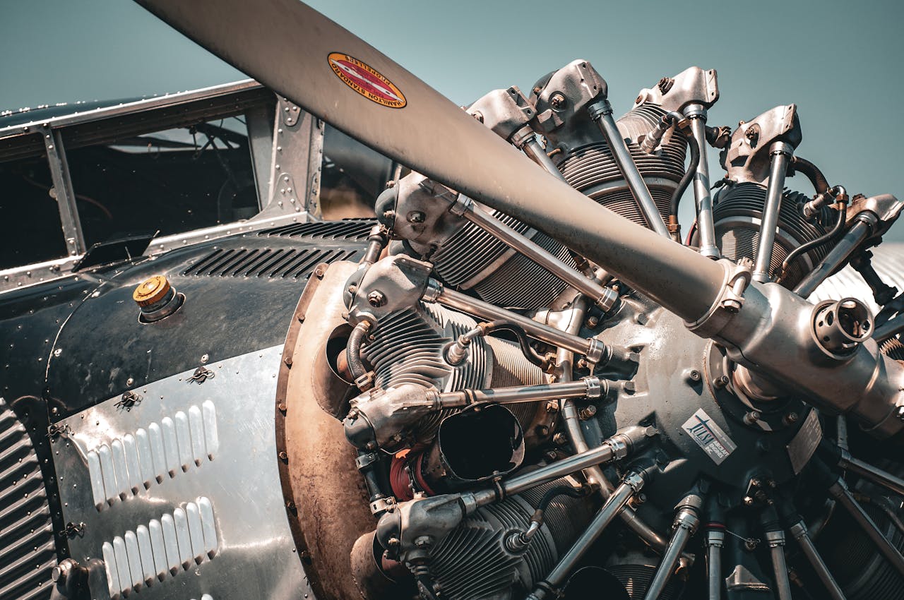 Detailed view of a vintage aircraft engine and propeller showcasing intricate mechanical design.